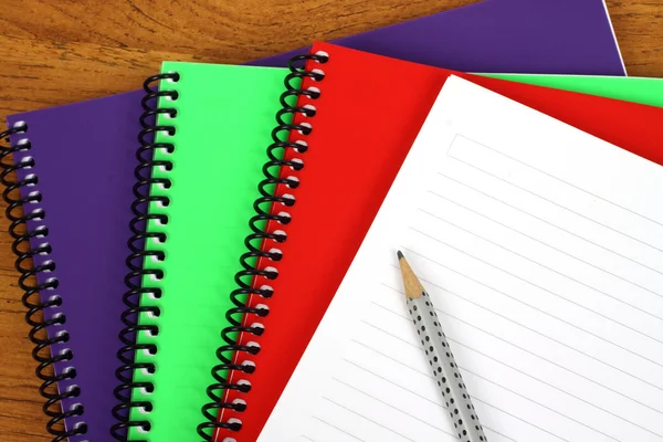 Colorful notebooks ond pencil — Stock Photo, Image