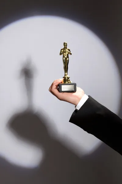 Oscar award in hand — Stock Photo, Image