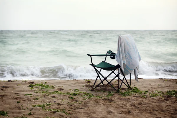 Folding chair on shore — Stock Photo, Image