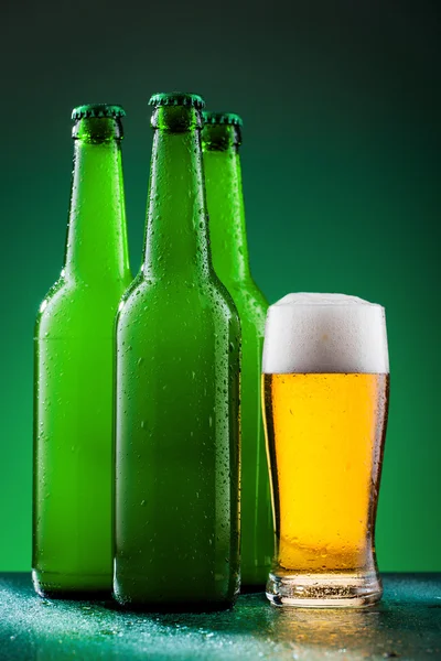 Beer bottles with full glass