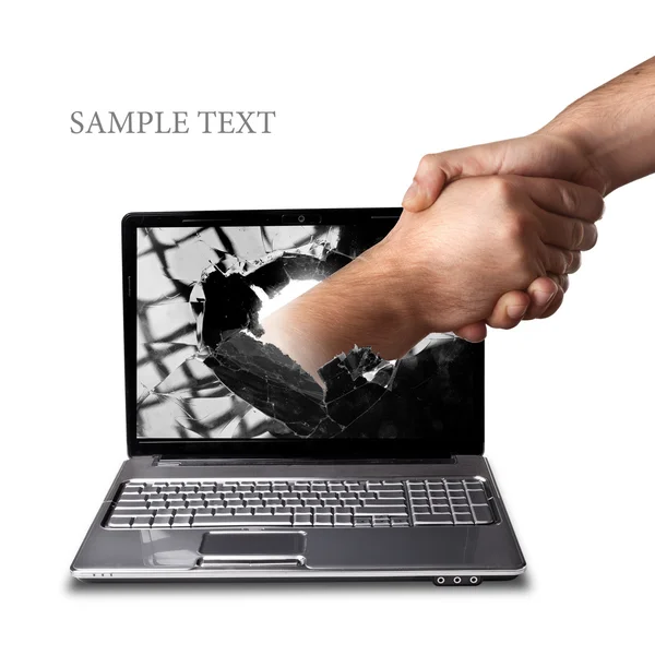A hand comes right out of the laptop screen to shake hands CONCEPT. — Stock Photo, Image