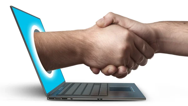 A hand comes right out of the laptop screen to shake hands CONCEPT — Stock Photo, Image