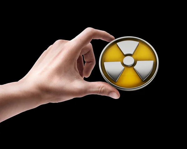 Man's hand holding radiation sign — Stock Photo, Image