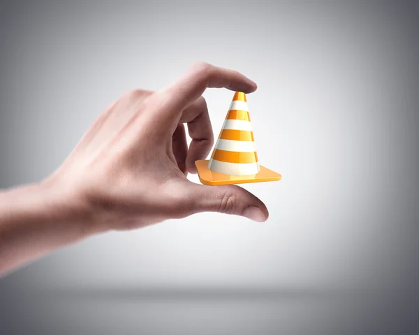 Hand holding road cone — Stock Photo, Image