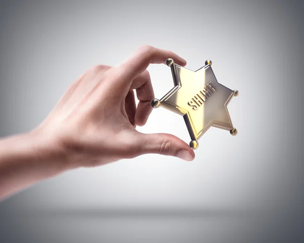 Hand holding Golden Sheriff Star — Stock Photo, Image