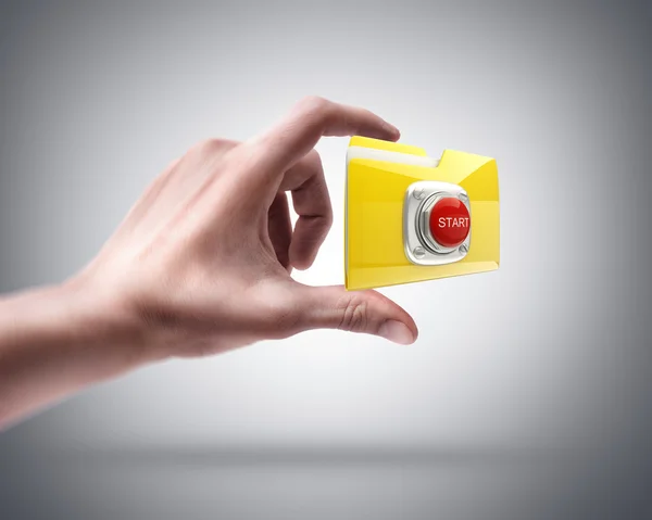 Hand holding Yellow folder with a symbol — Stock Photo, Image