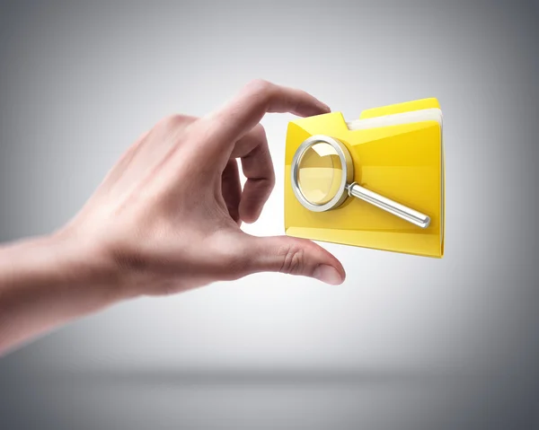 Hand holding Yellow folder with a symbol — Stock Photo, Image