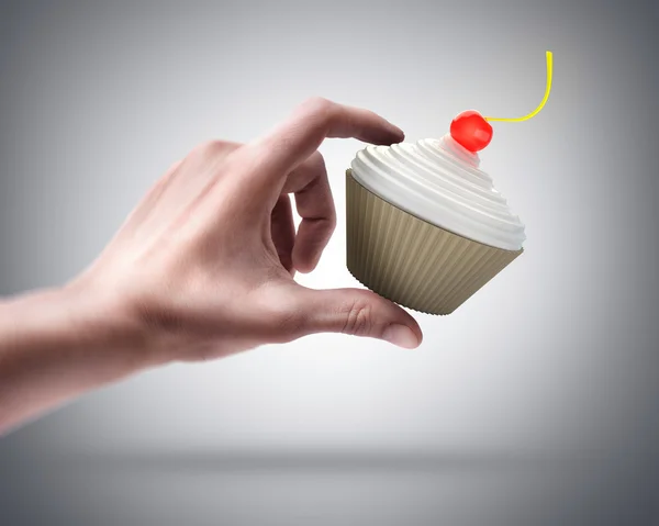 Hand holding cup-cake — Stock Photo, Image