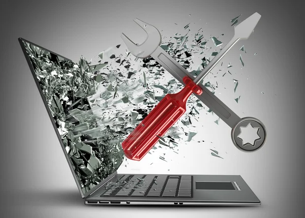 Screwdriver and Wrench exit by a monitor of laptop screen — Stock Photo, Image