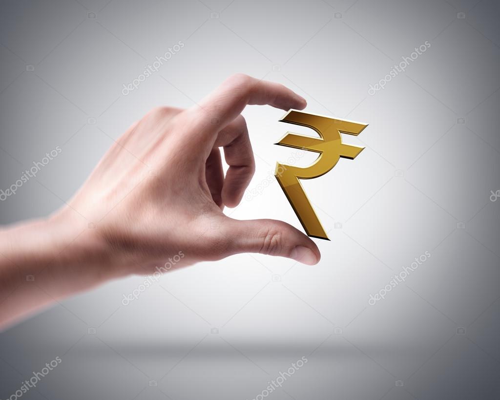 Hand holding Golden Indian rupee