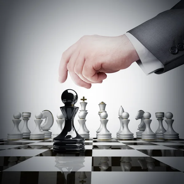 Hand holding black chess figure — Stock Photo, Image