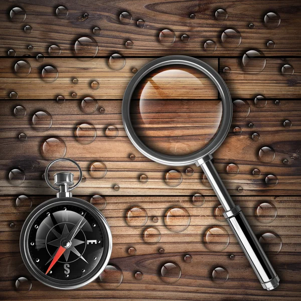 Antique brass compass and magnifying glass — Stock Photo, Image