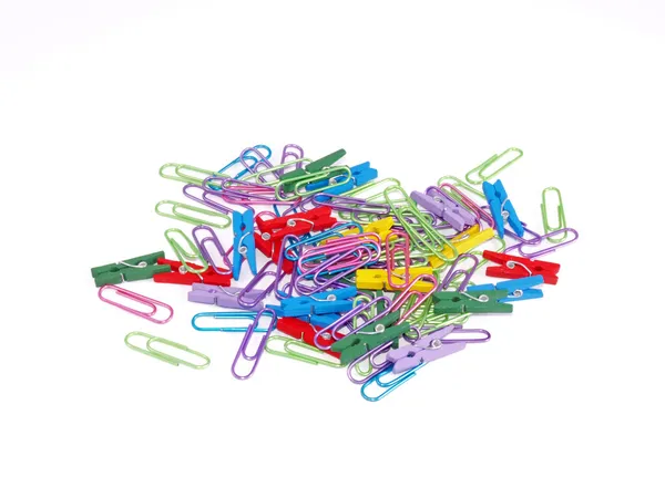 Paper clips and pegs on a white background. — Stock Photo, Image