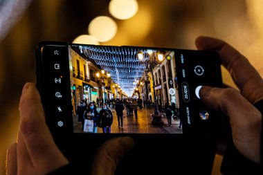  İspanya 'nın Saragossa şehrinde gece orijinal noel aydınlatması akıllı telefonlu fotoğraf