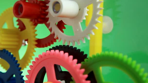 Working multicolor plastic toy cog of clockwork — Stock Video