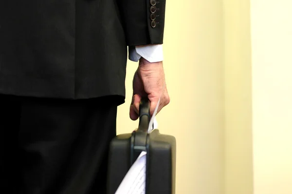 Businessman holding overloaded briefcase — Stock Photo, Image