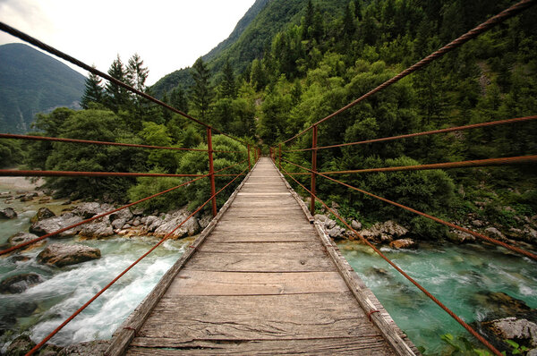 Wooden bridge over the mountain river