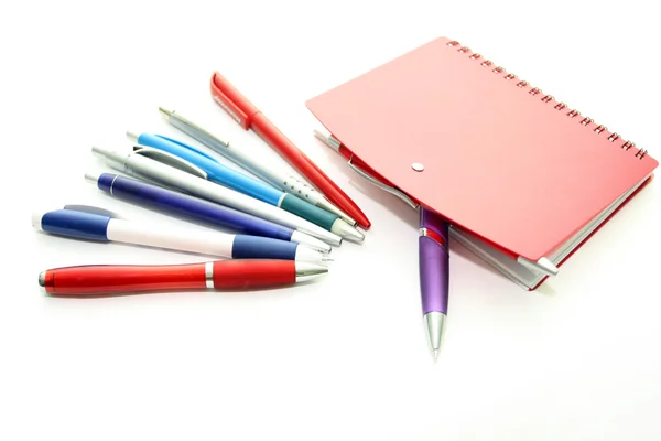 Set of office pens and red notebook — Stok fotoğraf