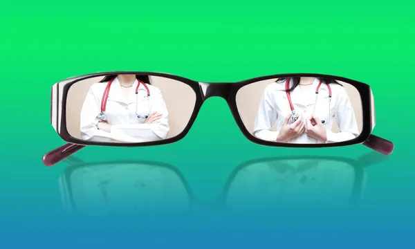 Miniatures doctor in glasses with mirror image — Stock Photo, Image
