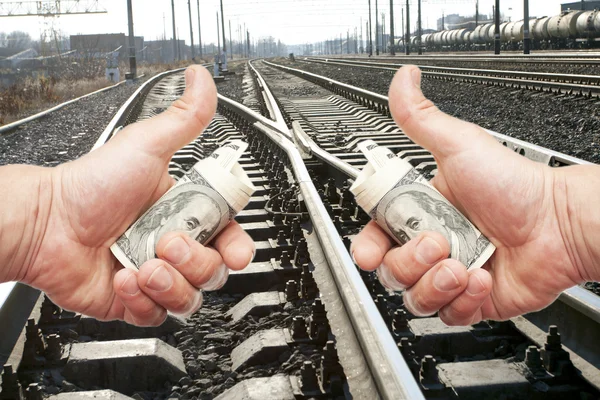 Hands with notes of dollars against the railroad — Stock Photo, Image