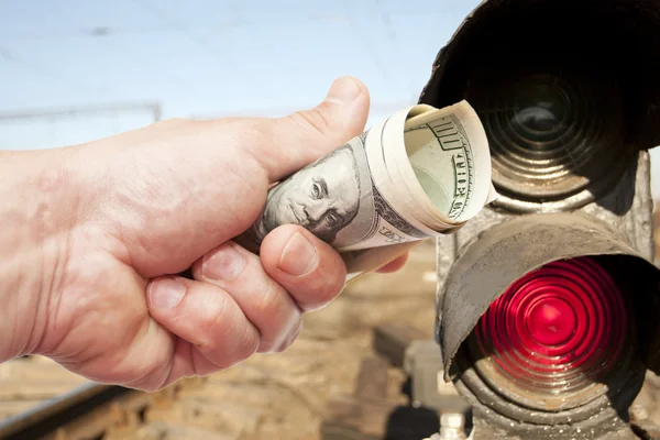 Hand with notes of dollars against light-odds — Stock Photo, Image