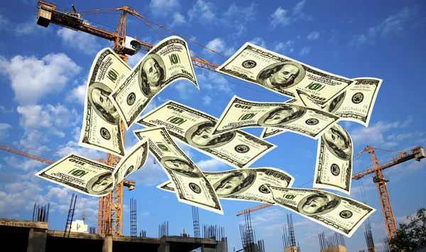 Falling notes of US dollar against cranes — Stock Photo, Image