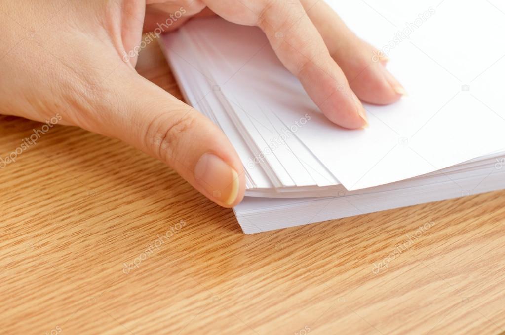 The process of paging white office paper with your fingers