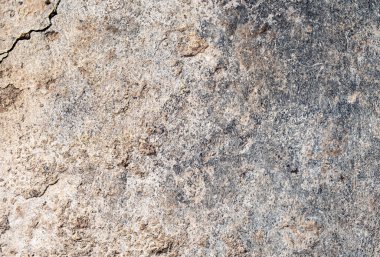 Beton dokusu ve gün ışığında biraz kum.