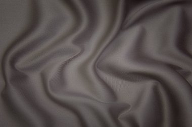 Doğal kahverengi ya da gri kumaş ya da kumaşın yakın çekim dokusu aynı renkte. Doğal pamuk, ipek, yün veya keten kumaş dokusu. Kumaş bezi arkaplanı.