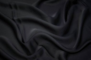 Kumaş dokusu, tasarım için arka plan. Siyah ipek, pamuk ya da yün kumaş. Dalgalı kumaşın güzel deseni.