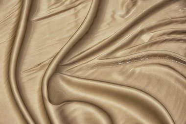 Doğal bej ya da fildişi kumaşın yakın çekim dokusu ya da kahverengi renkli kumaş. Doğal pamuk veya keten kumaş dokusu. Bej tuval arkaplanı.