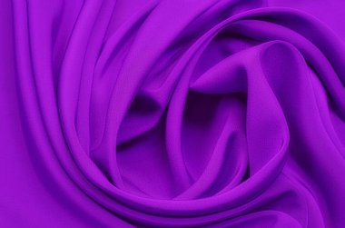 Doğal menekşe ya da mor kumaş ya da kumaşın yakın çekim dokusu aynı renkte. Doğal pamuk, ipek, yün veya keten kumaş dokusu. Menekşe veya mor tuval arkaplan deseni.