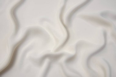 Doğal bej ya da fildişi kumaşın yakın çekim dokusu ya da kahverengi renkli kumaş. Doğal pamuk veya keten kumaş dokusu. Bej tuval arkaplanı.