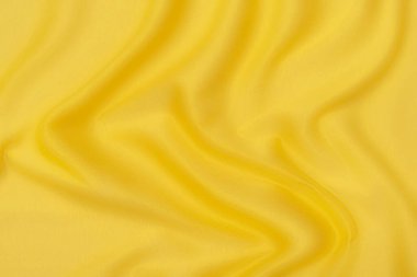 Doğal turuncu ya da sarı kumaş ya da kumaşın yakın çekim dokusu aynı renkte. Doğal pamuk, ipek, yün veya keten kumaş dokusu. Sarı tuval arkaplanı.