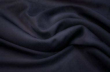 Doğal gri ya da siyah kumaş ya da kumaşın yakın çekim dokusu aynı renkte. Doğal pamuk, ipek, yün veya keten kumaş dokusu. Siyah tuval arkaplan.