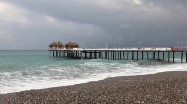 Turkish beach near Alanya and the sea below lowering thunder clouds