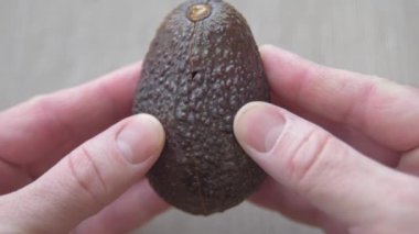 The cook opens an avocado and finds that it is rotten