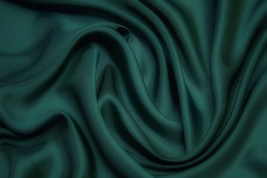Doku, arka plan, desen. Yeşil ipek kumaş dokusu. Güzel zümrüt yeşil yumuşak ipek kumaş.