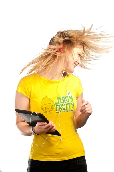 Young attractive girl dancing with a tablet — Stock Photo, Image