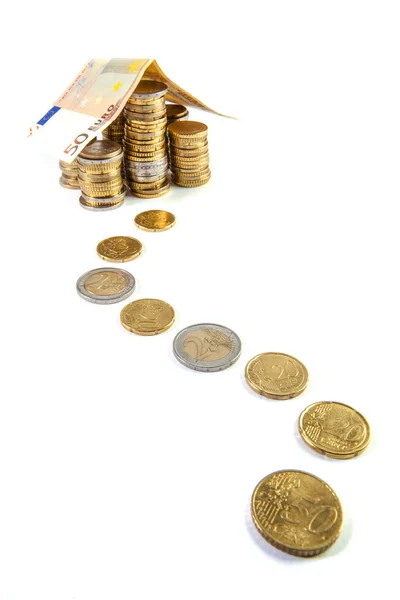 Home build with euro bank notes with a path made of coins - busi — Stock Photo, Image