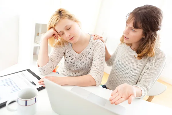 Girl sleeping instead of working with her friend — Stock Photo, Image