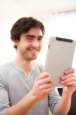 genç gülümseyen adam tablet kullanma