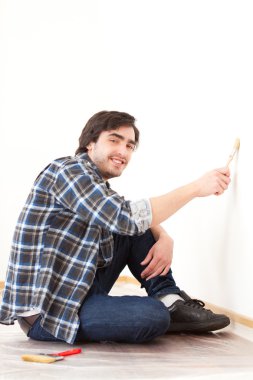 çekici bir genç adam onun yeni düz bir duvar boyama
