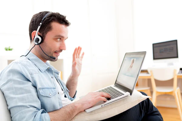 Young relaxed man video-calling on Internet — Stock Photo, Image