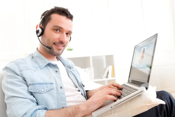 Young relaxed man video-calling on Internet — Stock Photo, Image