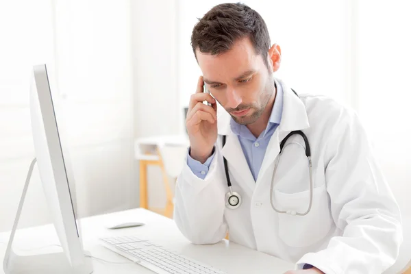 Portrait of a young doctor phoning a patient — Stock Photo, Image