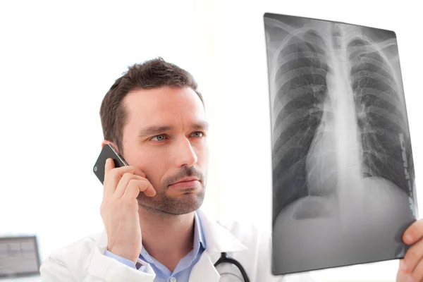 Young doctor calling patient for results — Stock Photo, Image