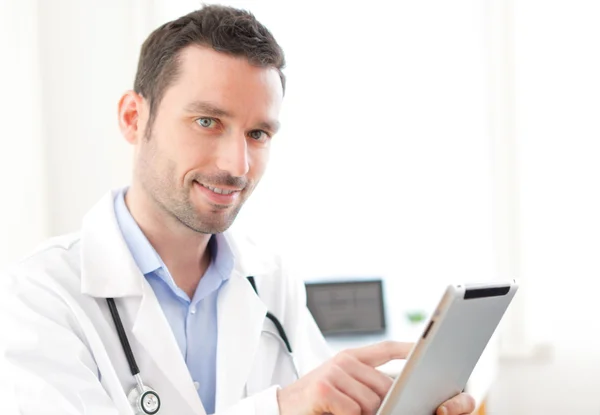 Portrait of a young doctor using tablet at work — Stock Photo, Image