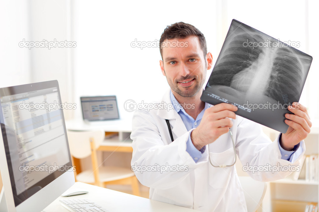 Young doctor analysing a radiography
