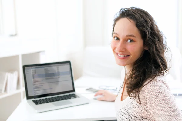 Porträtt av leende ung affärskvinna på jobbet — Stockfoto